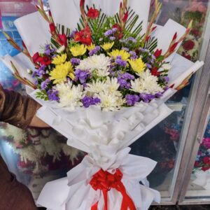 White and Yellow Chrysanthemums Bouquet With Purple Leaves In White Wrap