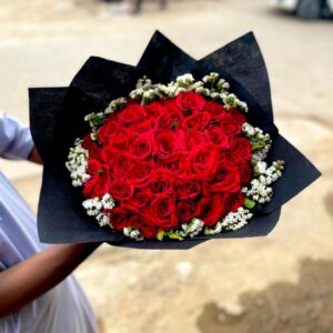 red & statice bouquet in black wrap